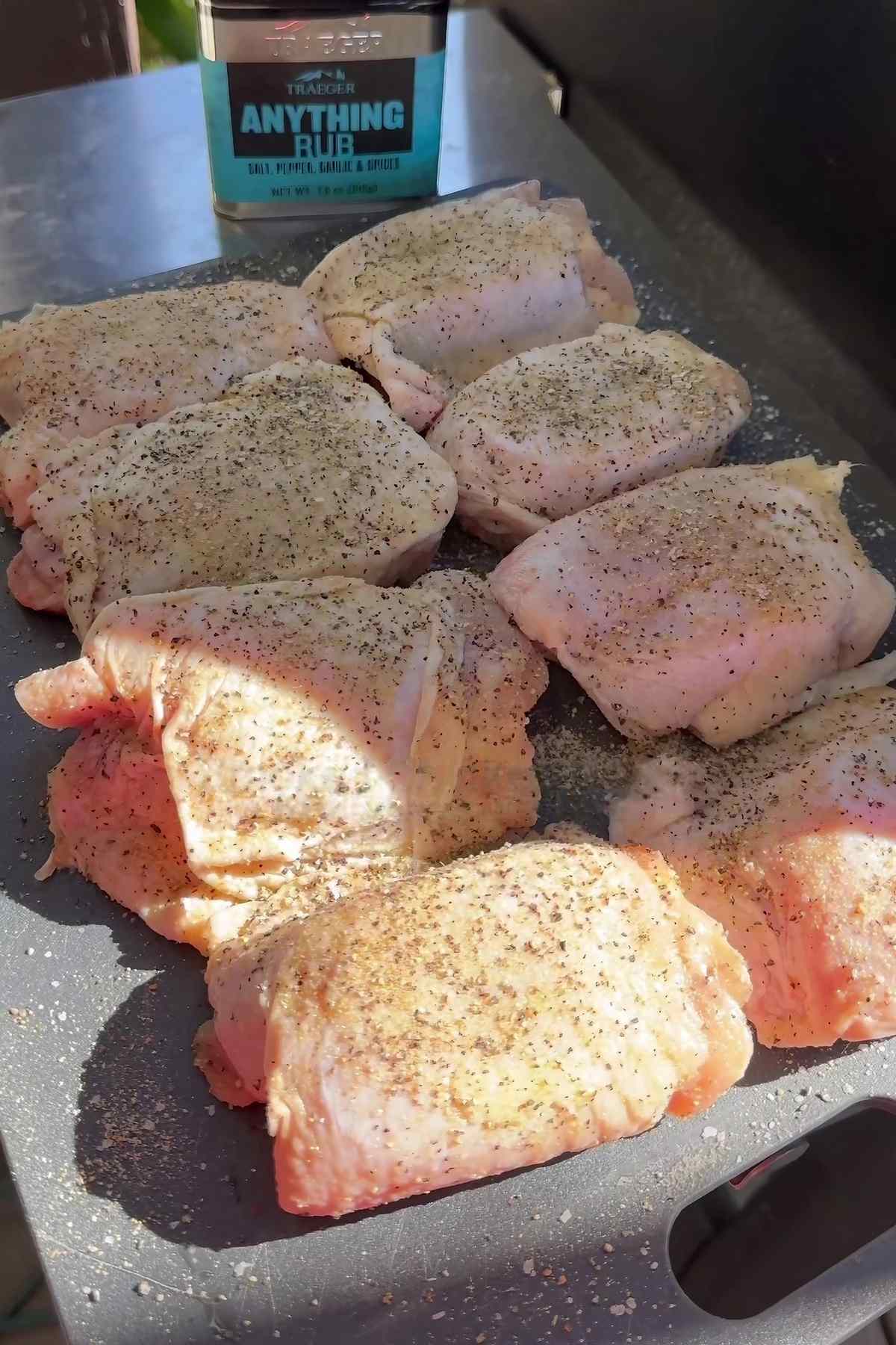 raw seasoned chicken thighs on a table